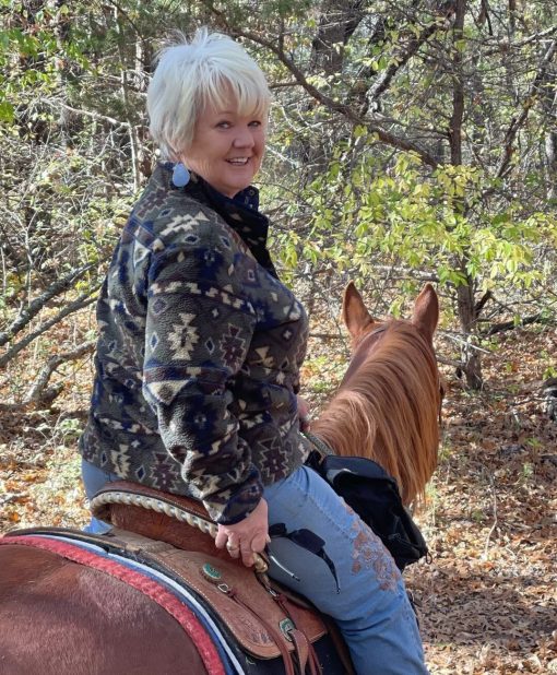 Picture of KK's owner, Kim, on the back of her faithful gelding, Fireball